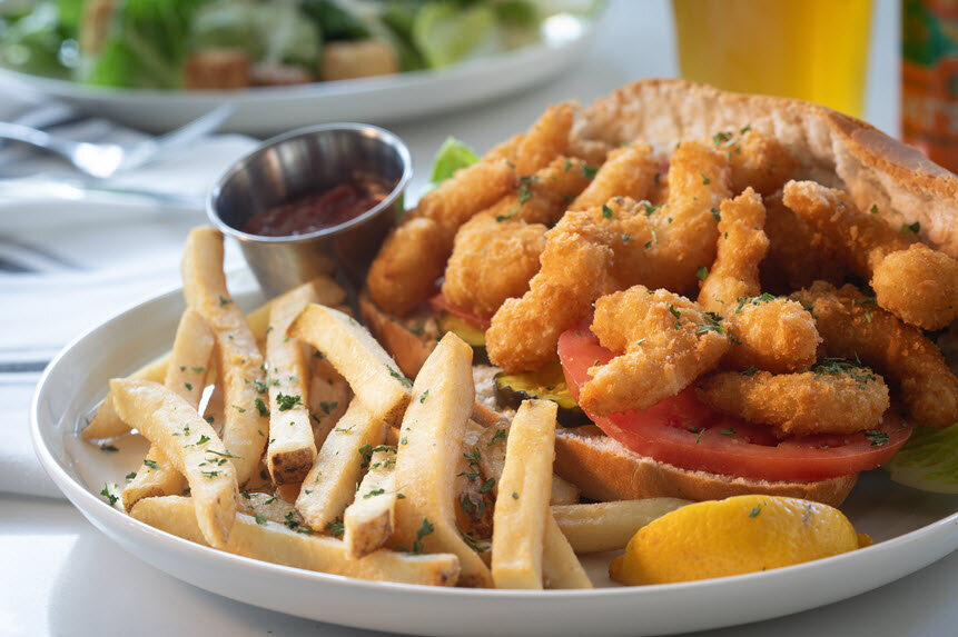 a plate of food with a drink and a glass of beer