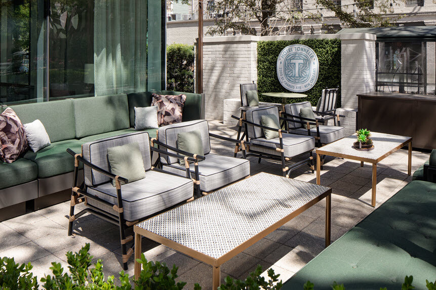 a patio with a group of chairs and tables