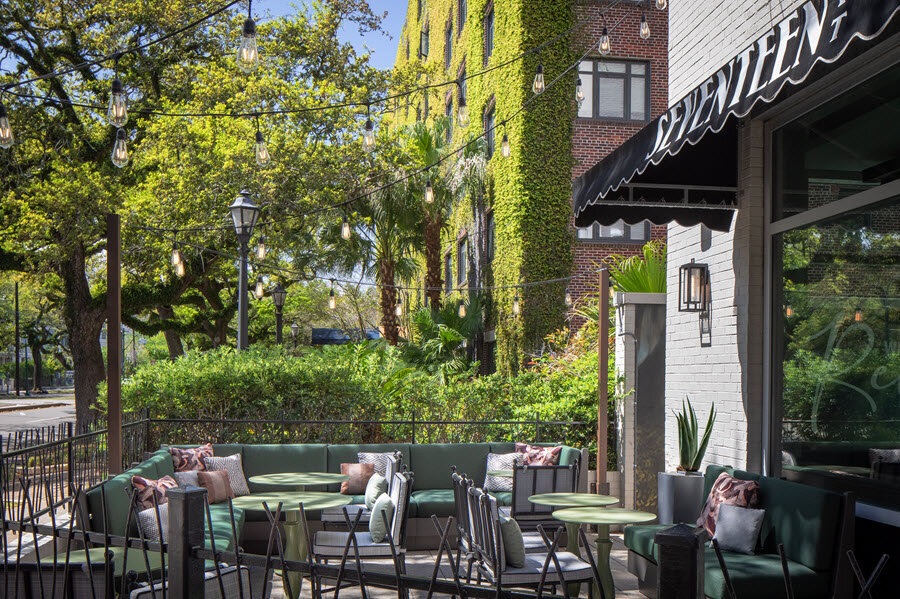 a patio area with a group of tables and chairs