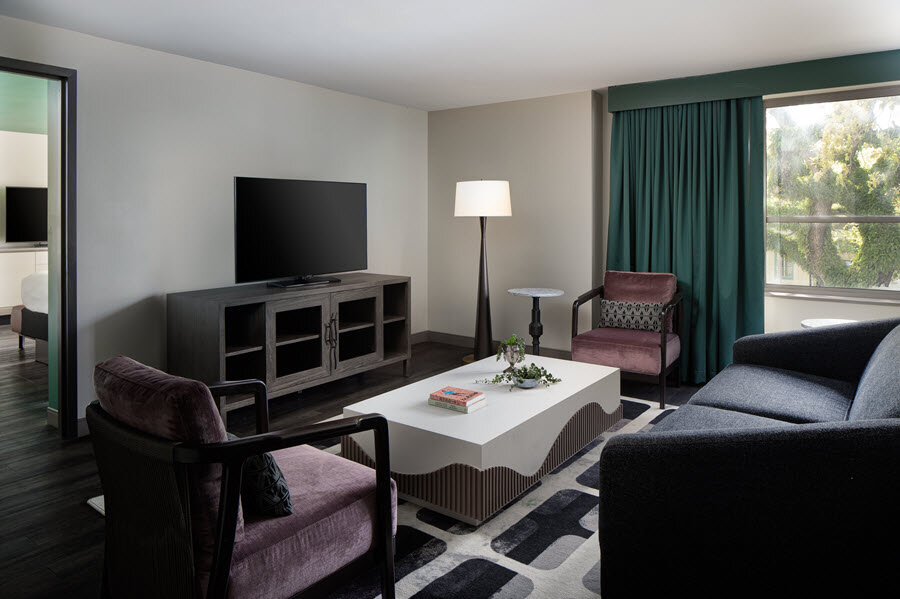 a living room with a tv and couches