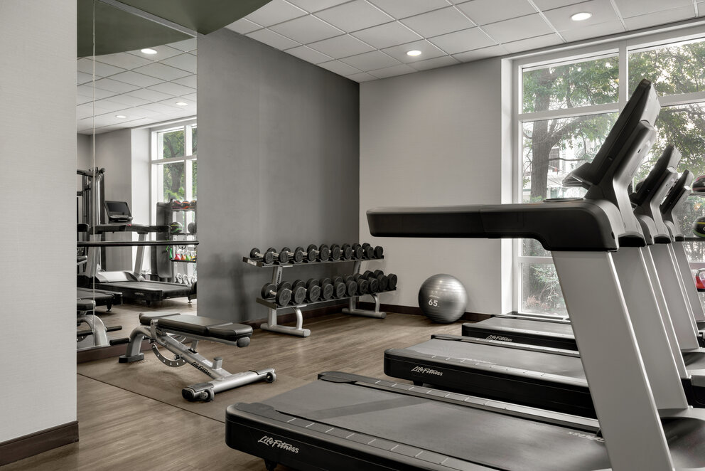 a gym with treadmills and exercise equipment