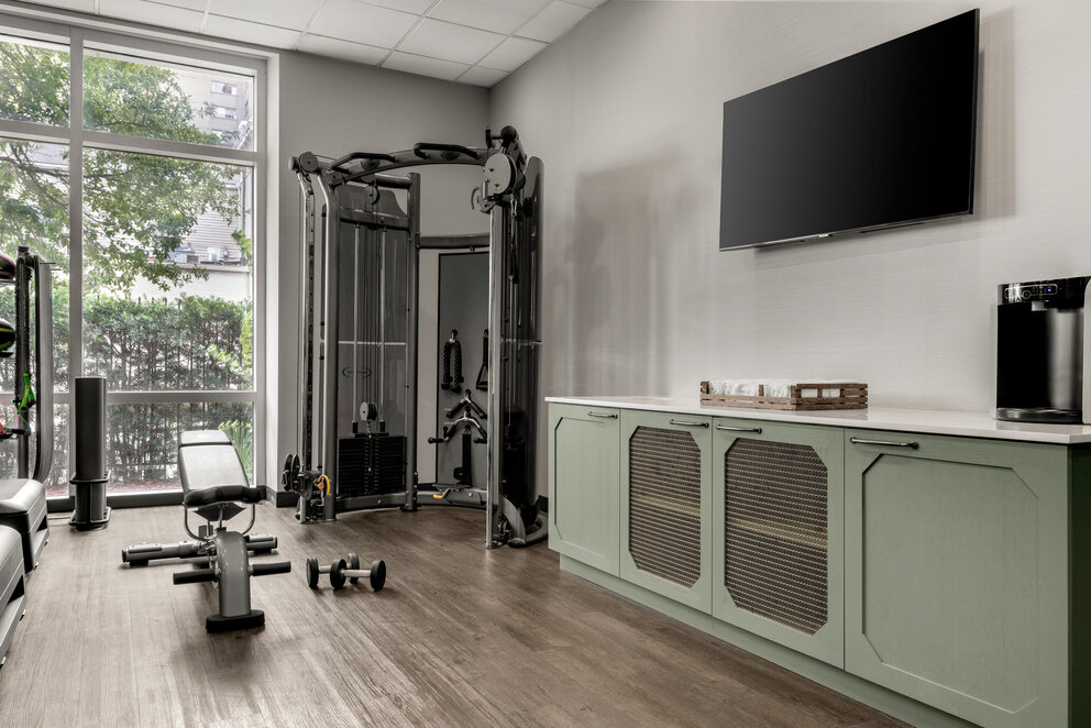 a room with exercise equipment and a television