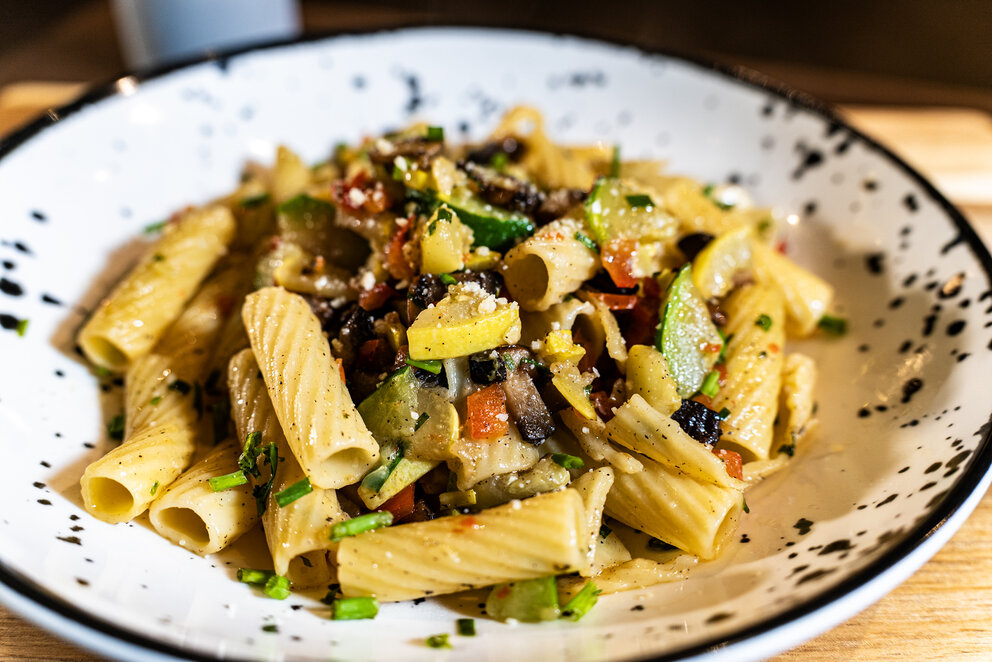 a plate of pasta with vegetables