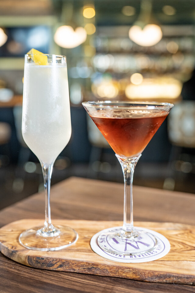 two glasses of drinks on a table